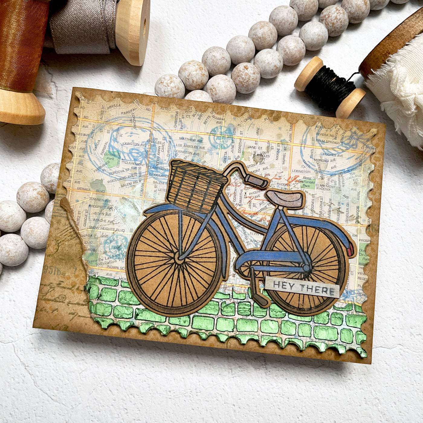 Mixed Media card featuring a bike and travel theme map background.